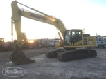 Used Komatsu under cloudy sky